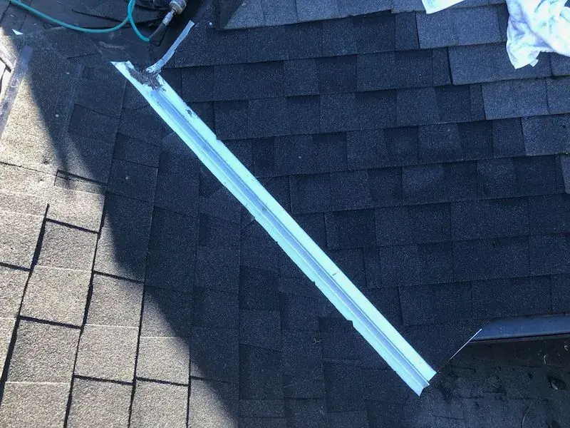 Open valley with metal on a shingle roof in Northern California
