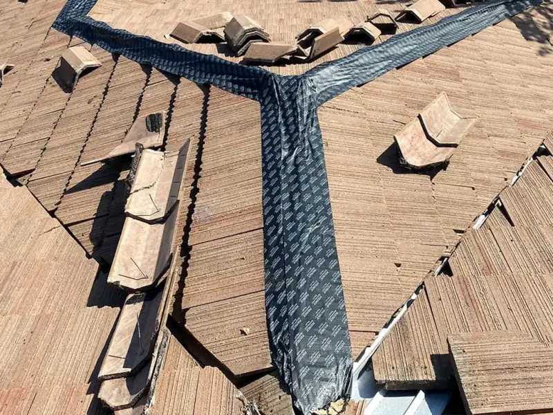 New hip flashing and underlayment installed on the wood shake roof before the shakes were re-laid
