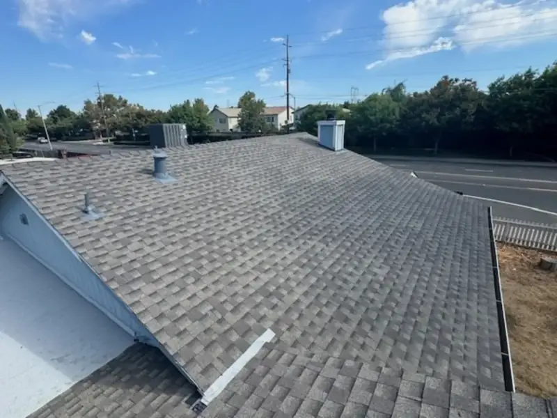 Uniform new asphalt shingle surface across the full roof plane