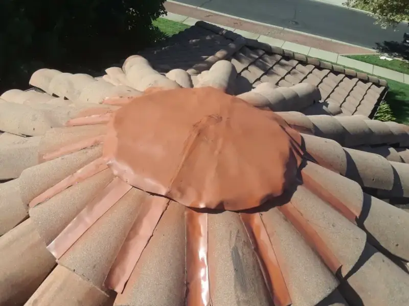 New color-matched metal apex cap and hip flashing formed over the turret peak