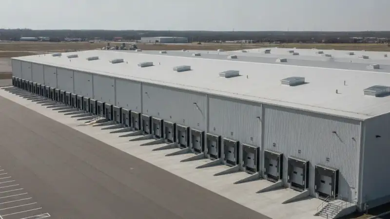 Large industrial warehouse building with an expansive flat membrane roof