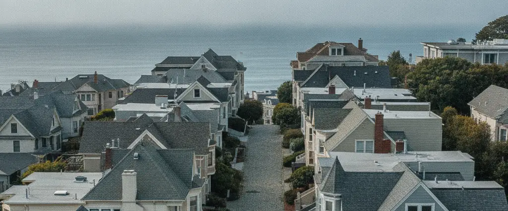 Well-maintained residential rooftops in Kensington, Contra Costa County, California, with rolling hills and coastal haze