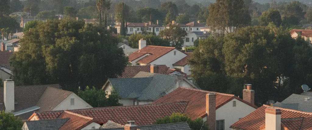 Well-maintained residential rooftops in Altadena, Los Angeles County, California, with hazy coastal hills beyond