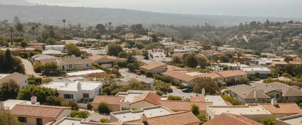 Well-maintained residential rooftops in Santa Monica, Los Angeles County, California, with hazy coastal hills beyond