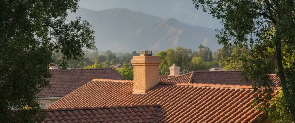 Well-maintained residential rooftops in Tarzana, Los Angeles County, California, with hazy coastal hills beyond
