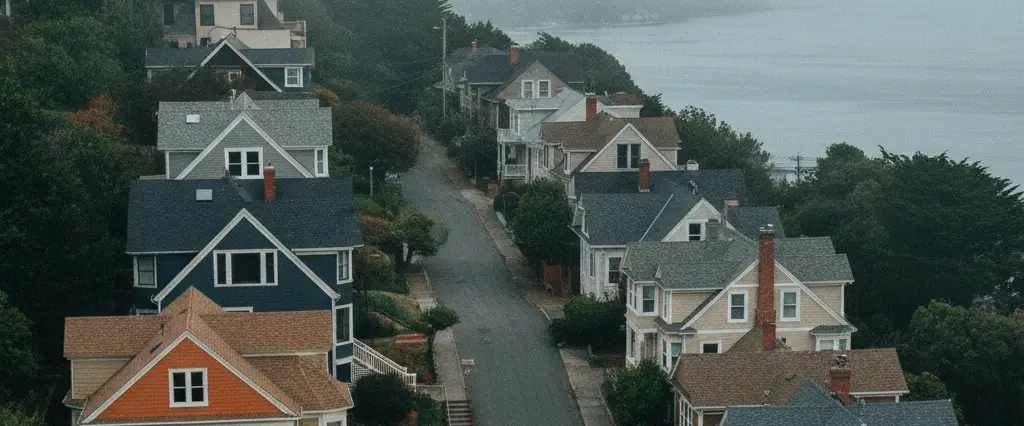 Well-maintained residential rooftops in Sausalito, Marin County, California, with rolling hills and coastal haze