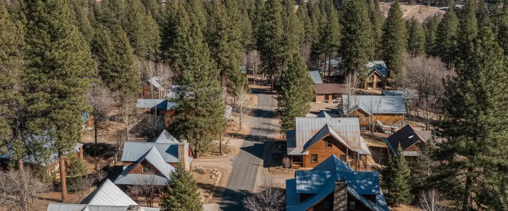Well-maintained residential rooftops in Columbia, Tuolumne County, California, with pine forest and the Sierra beyond