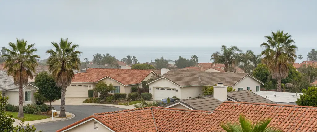 Well-maintained residential rooftops in Oxnard, Ventura County, California, with hazy coastal hills beyond