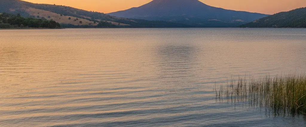 Lake County Clear Lake ringed by oak hills with the volcanic cone of Mount Konocti rising over the water