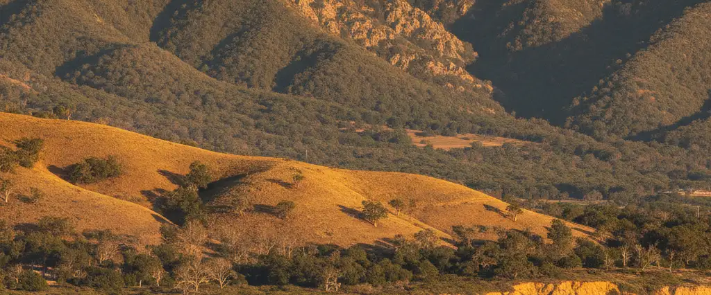 Santa Barbara County south-facing coast with the Santa Ynez Mountains behind the shore and faint Channel Islands