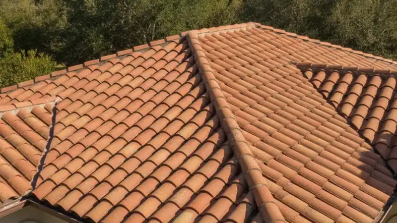 Concrete and clay tile roof on a home with barrel-profile tile courses