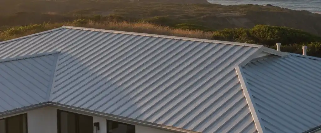 An aluminum standing-panel metal roof with clean vertical seams on a modern coastal California home