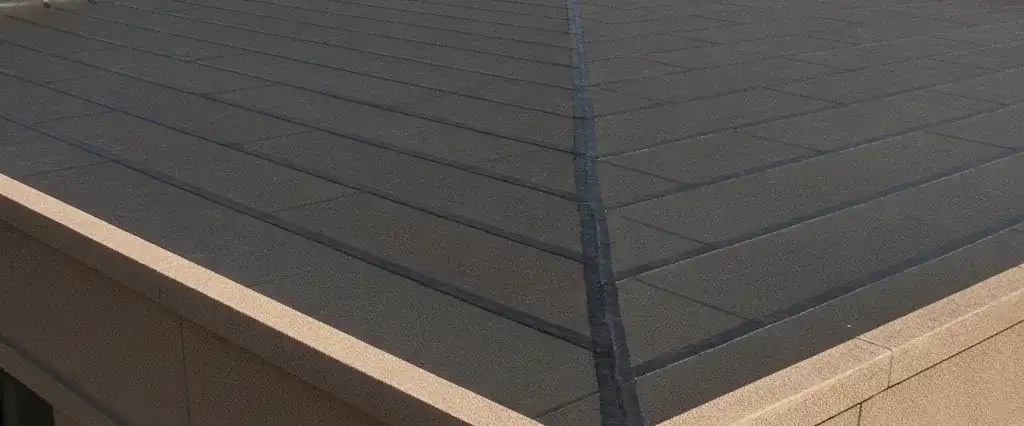 A flat black EPDM rubber membrane roof on a low-slope California building