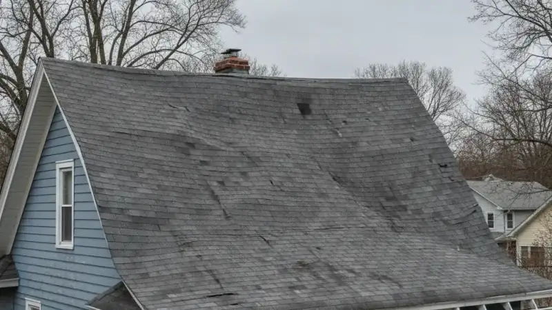 Visibly sagging and uneven roofline indicating structural roof failure