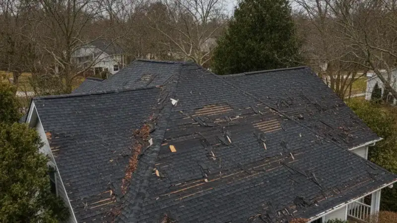 Roof with widespread damage across multiple areas indicating replacement