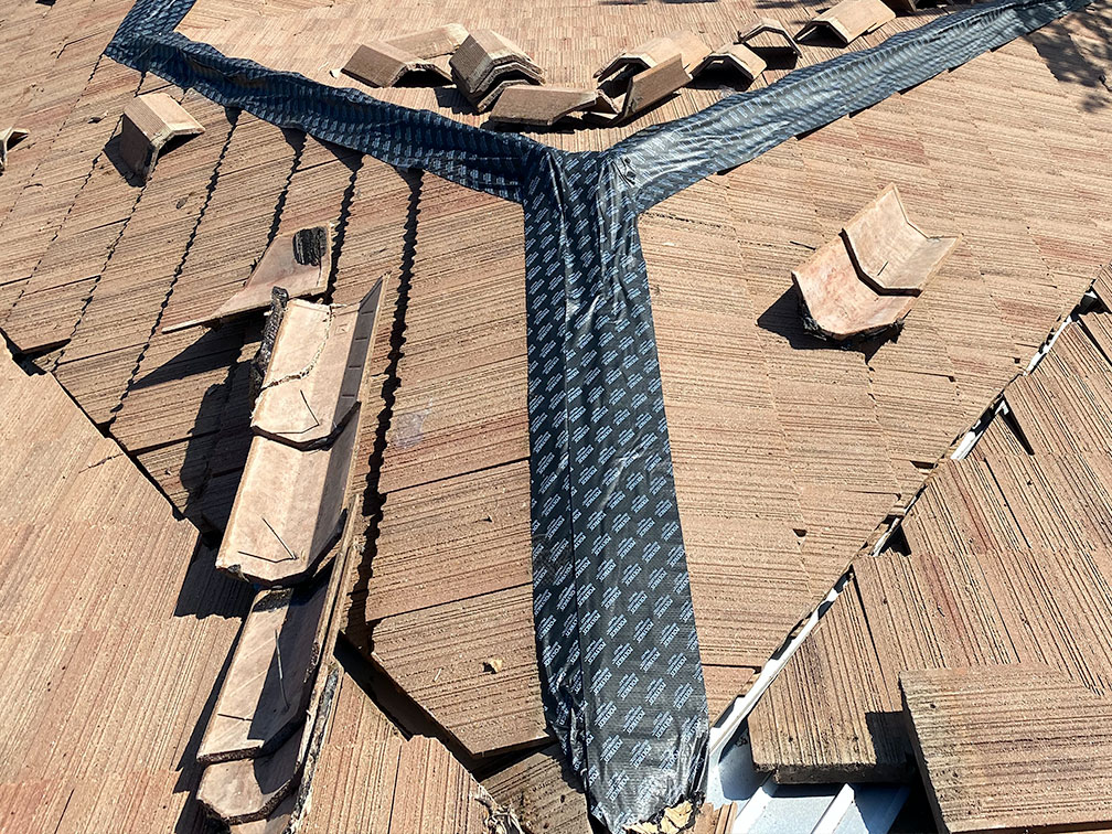 close up of a repaired brown flat tile roof