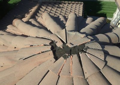 close up of a tile roof with a damaged ridge cap