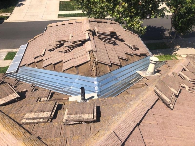 a tile roof that is being repaired