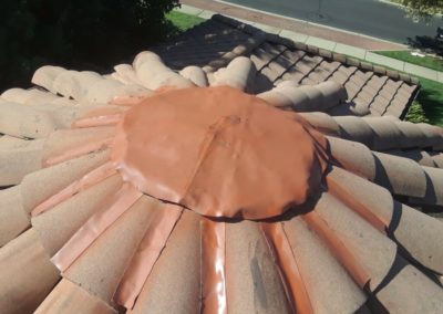 close up of a ridge cap on a tile roof after a repair