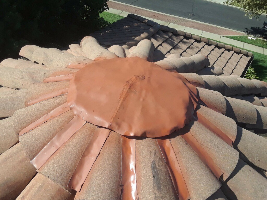A close up of a ridge cap on a tile roof after a repair