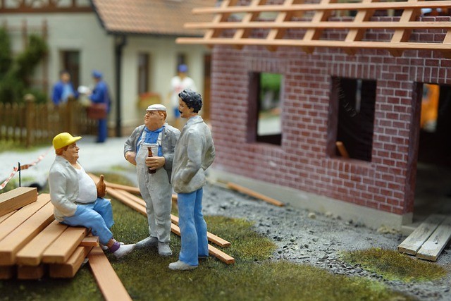 Model construction workers on a new roof