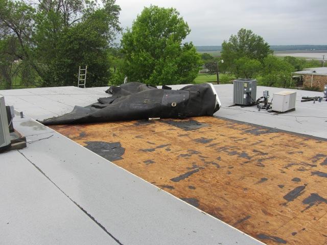 A torn off roofing membrane 